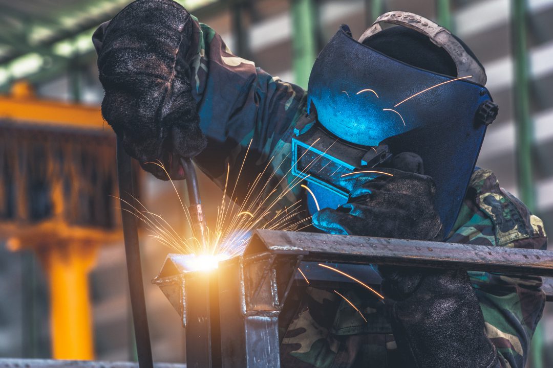 Welder is welding metal