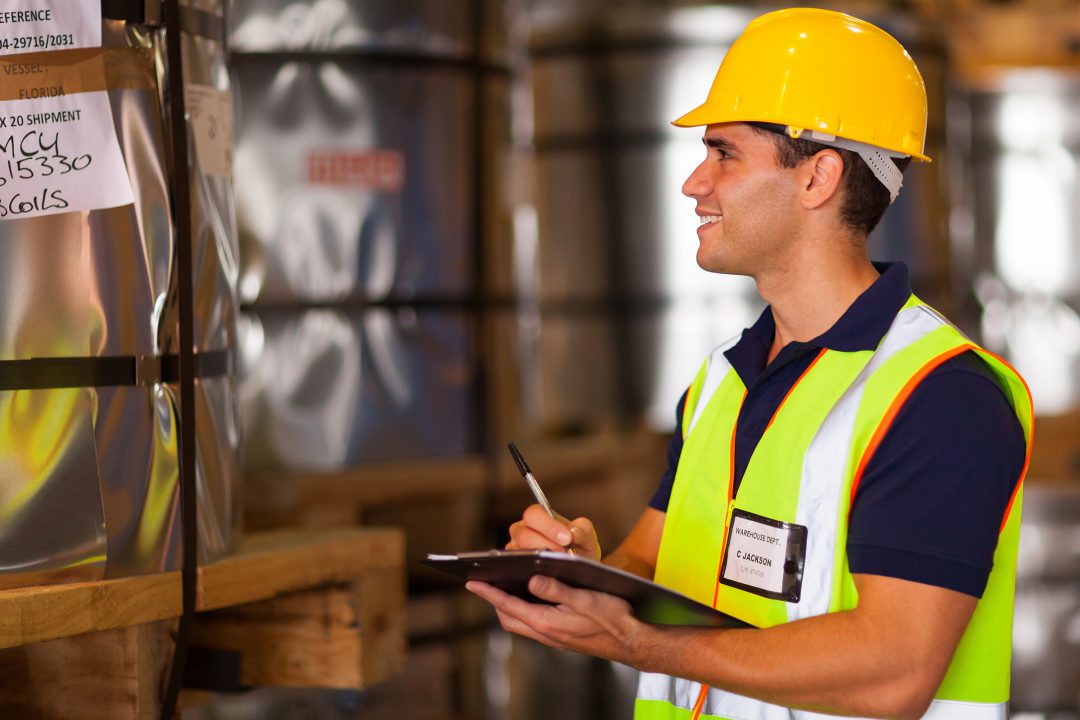 worker recording steel rolls